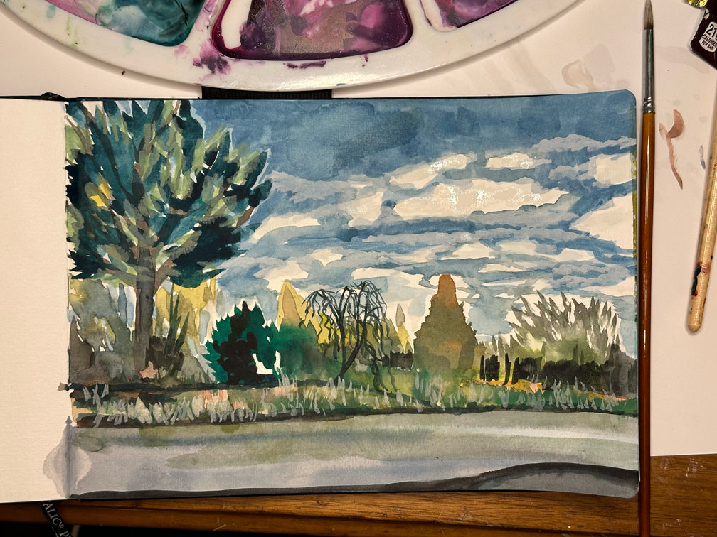 A photo of this artwork, "Backroads" while it is being watercolor painted