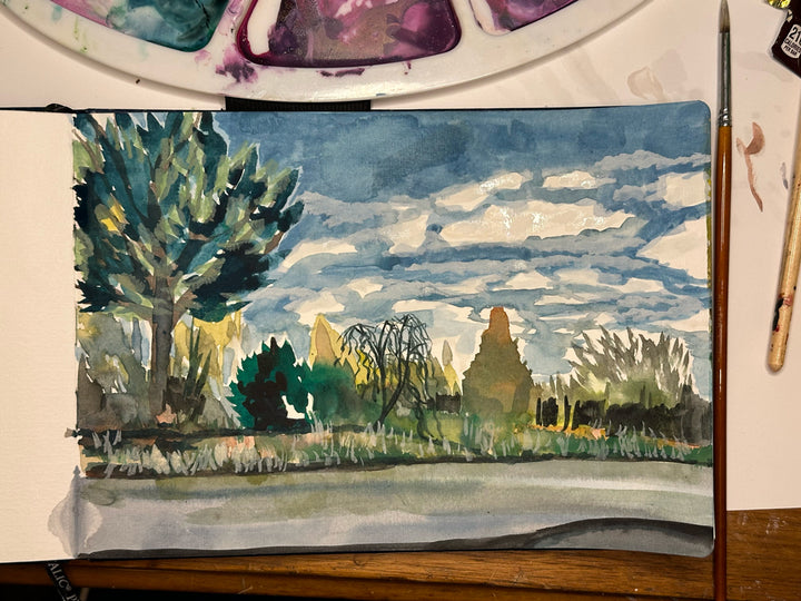 A photo of this artwork, "Backroads" while it is being watercolor painted