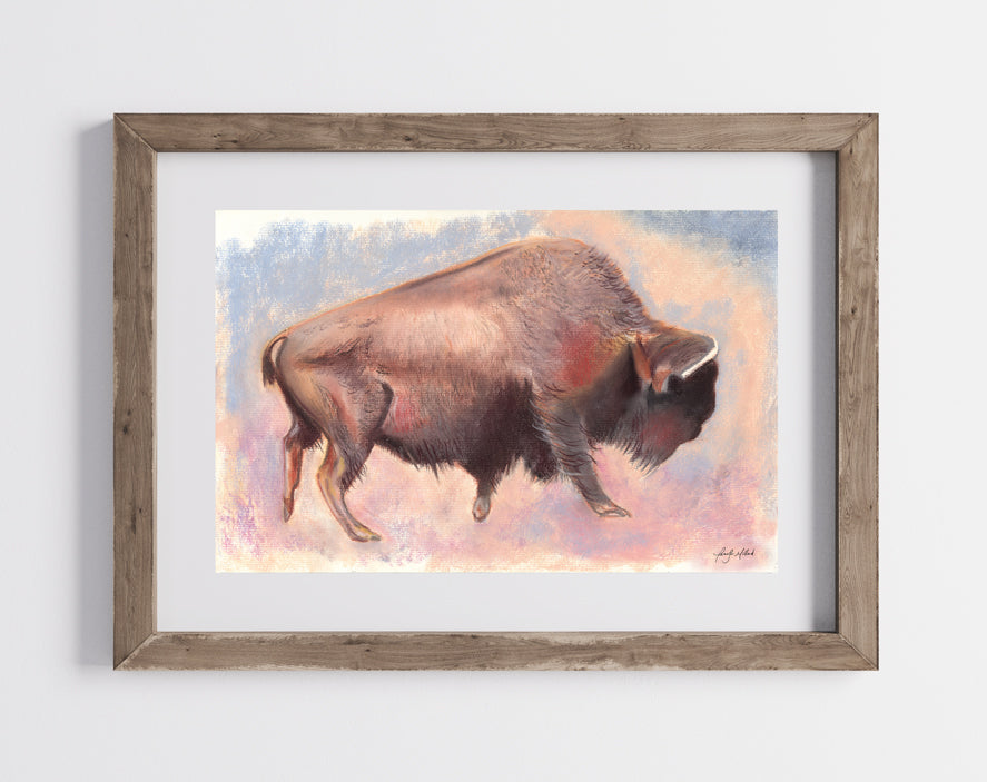 A photo of the lone bison print framed in a natural wood frame with a white mat.