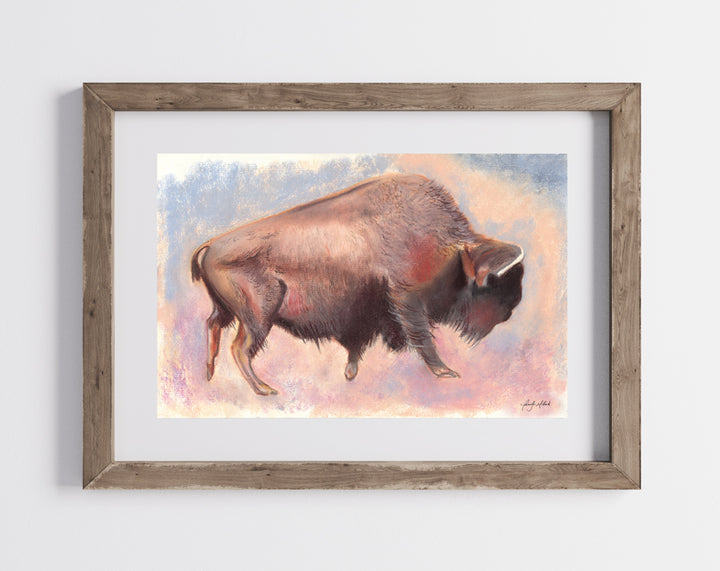 A photo of the lone bison print framed in a natural wood frame with a white mat.