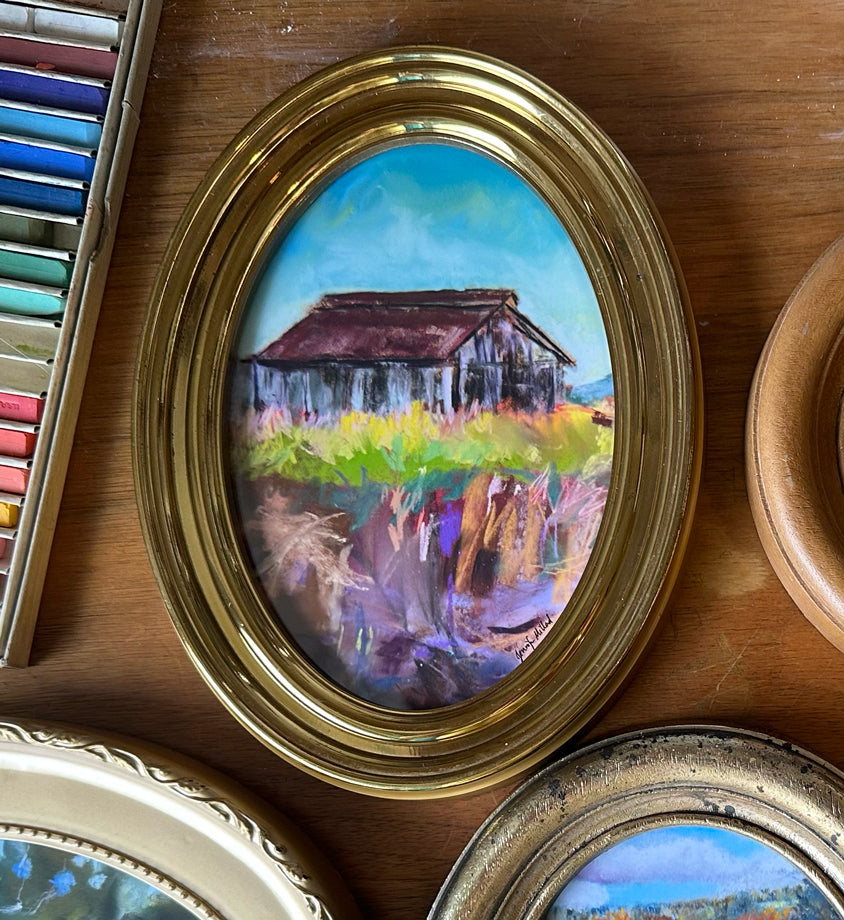 This is a photo a giclee print of an old tobaccco farm in an abstract style in a gold oval frame.
