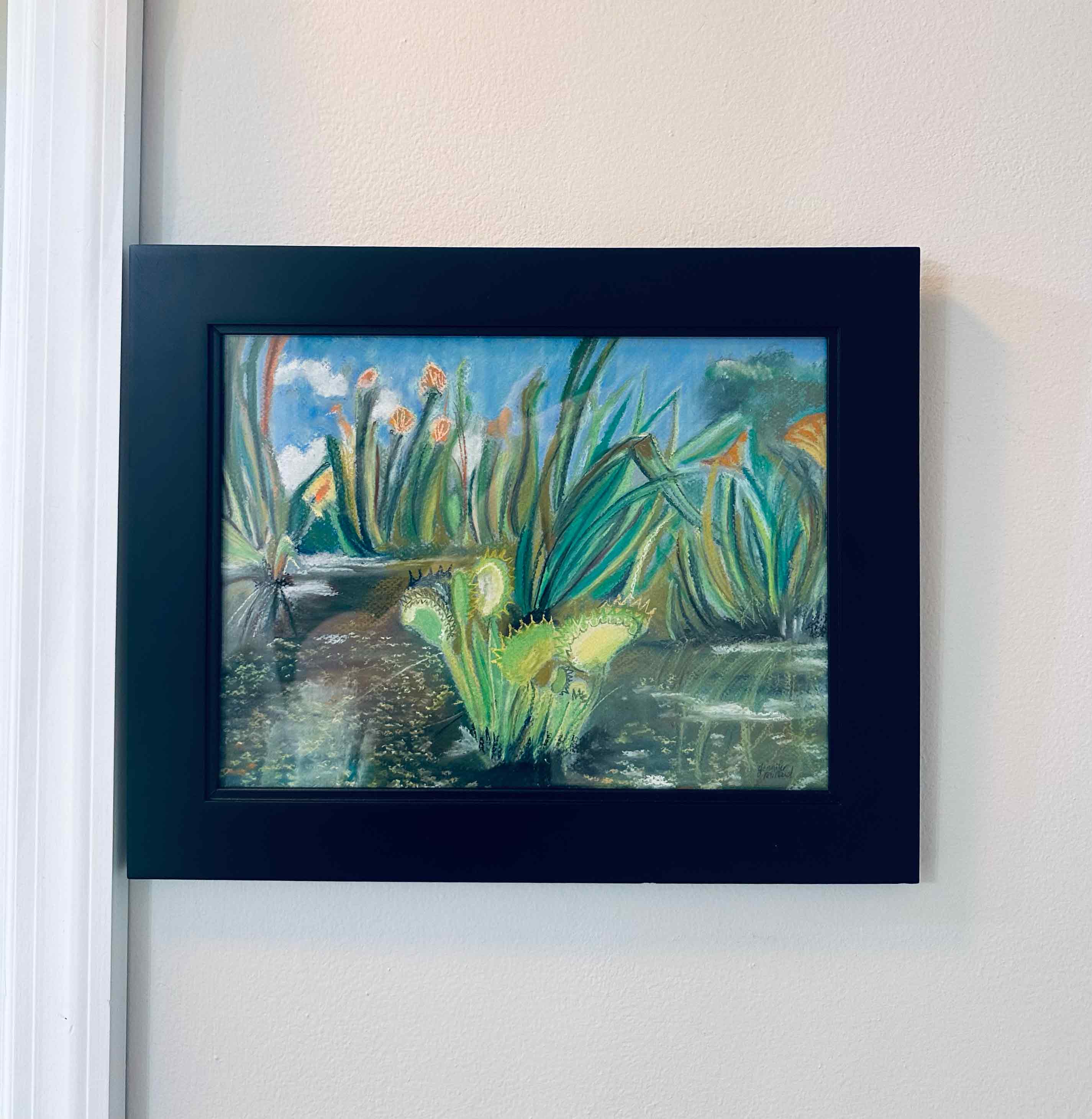 A photo of this original artwork of a venus fly trap in a black frame behind glass.