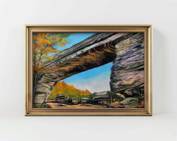 A giclee print of Natural Bridge near Slade, Kentucky in a gold frame.