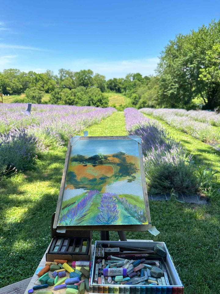 A photo of Jennifer's painting in progress of a lavender farm in bloom with full rows of lavender.