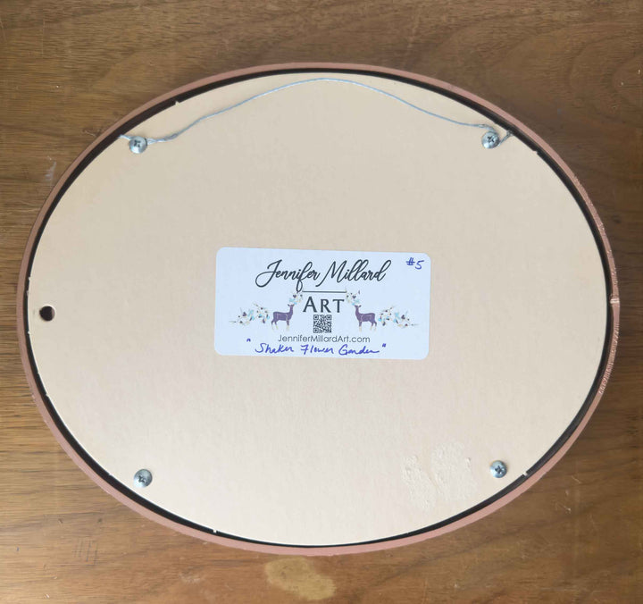 The back of this vintage oval frame shows the wire for immediate wall display.