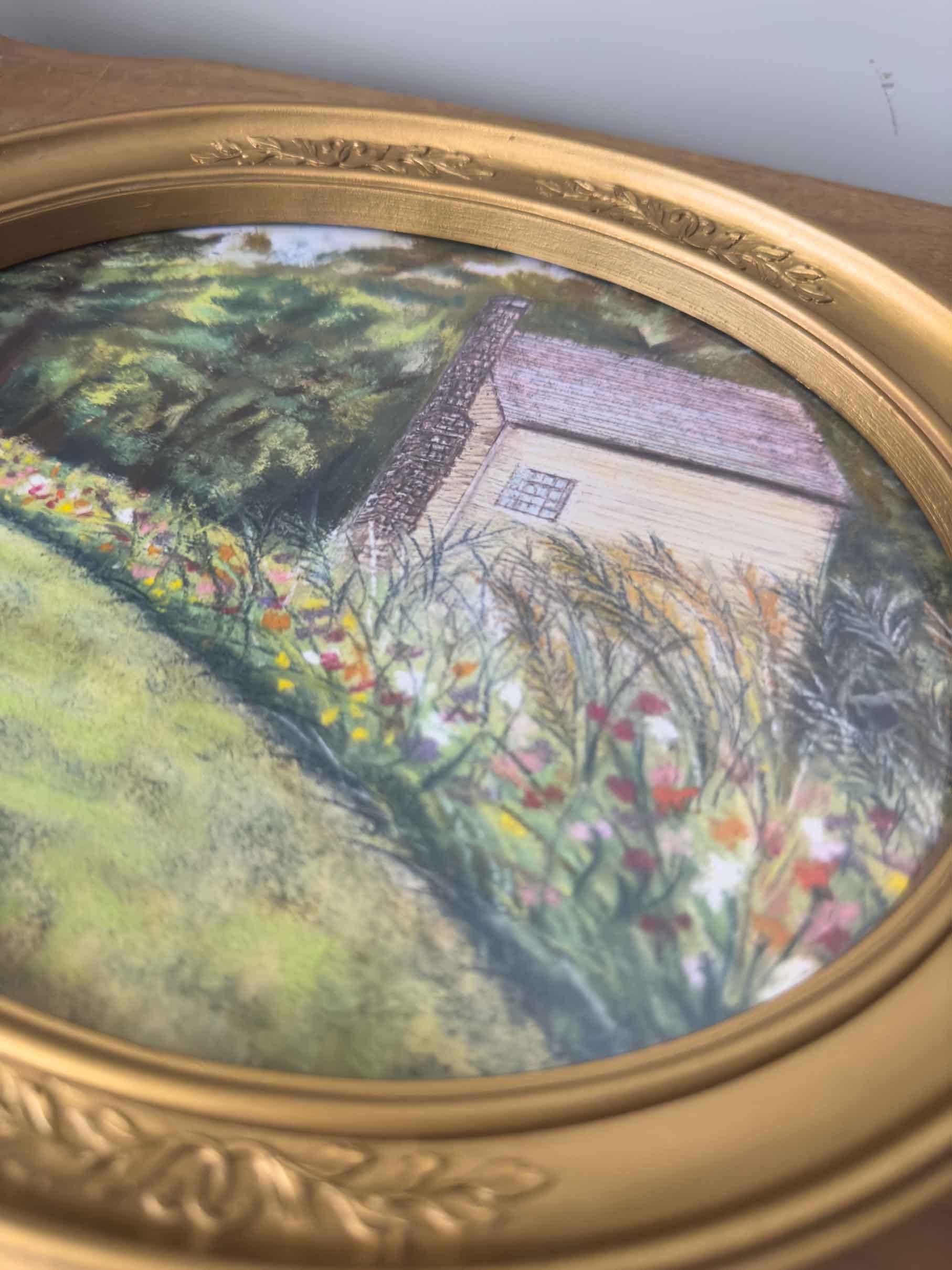 An up-close view of this print under glass shows the soft pastel details of the flowers and building.