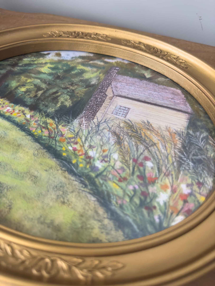 An up-close view of this print under glass shows the soft pastel details of the flowers and building.