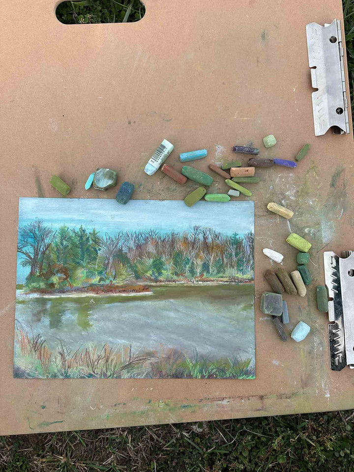 The progress of a painting of Lake Reba using soft pastels.