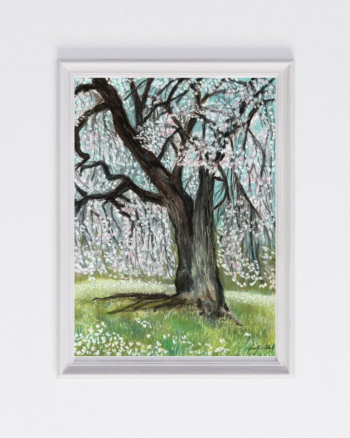 This print of a weeping cherry blossom tree is full of white and pink blooms that swing and sway in the spring breeze. This print is displayed in a simple white frame.