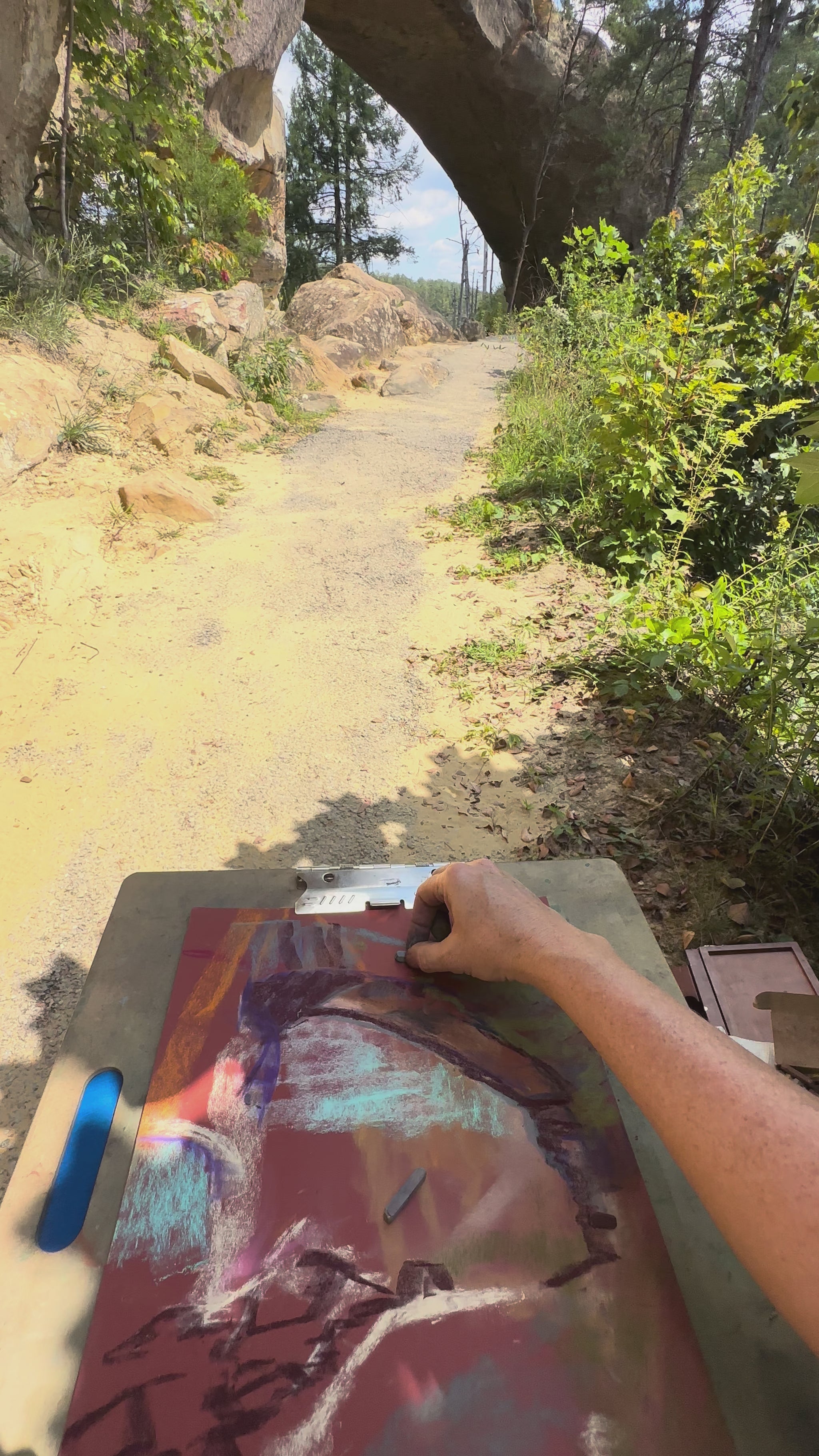 Artist Jennifer Millard is seen sketching Sky Bridge, a natural arch in Red River Gorge en plein air.