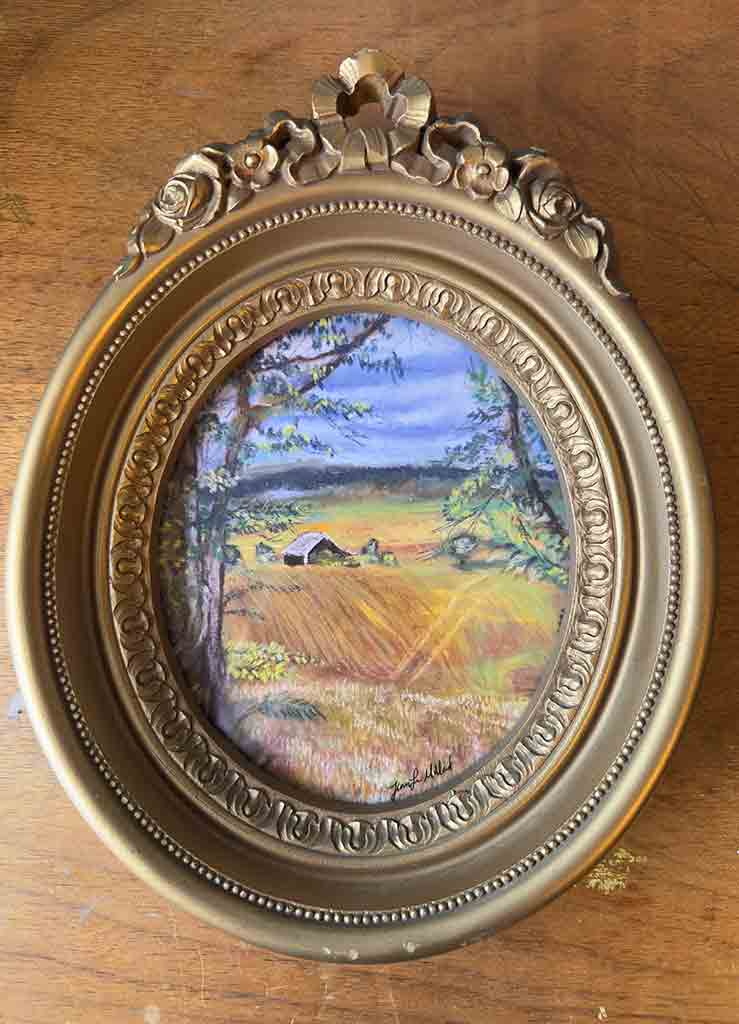 Up-close view of this beautiful ornate vintage oval frame displaying a giclee farmland print.