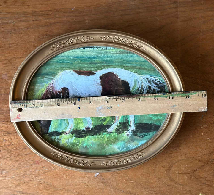A photo of a horse in a vintage gold oval frame is measured with a ruler to be almost 11" in width.