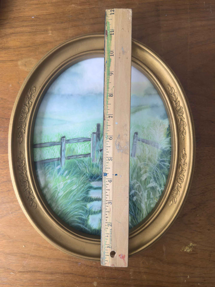 This print in an vintage oval frame is measured with a ruler at almost 11" in height.